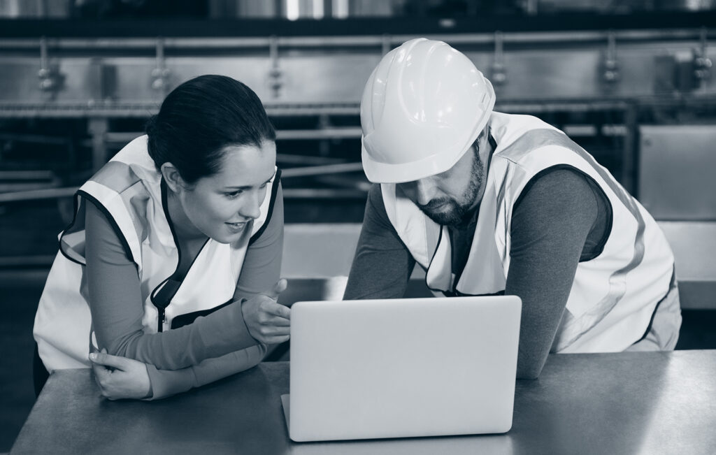 Mann og kvinne ser over produksjonsplanleggingen.